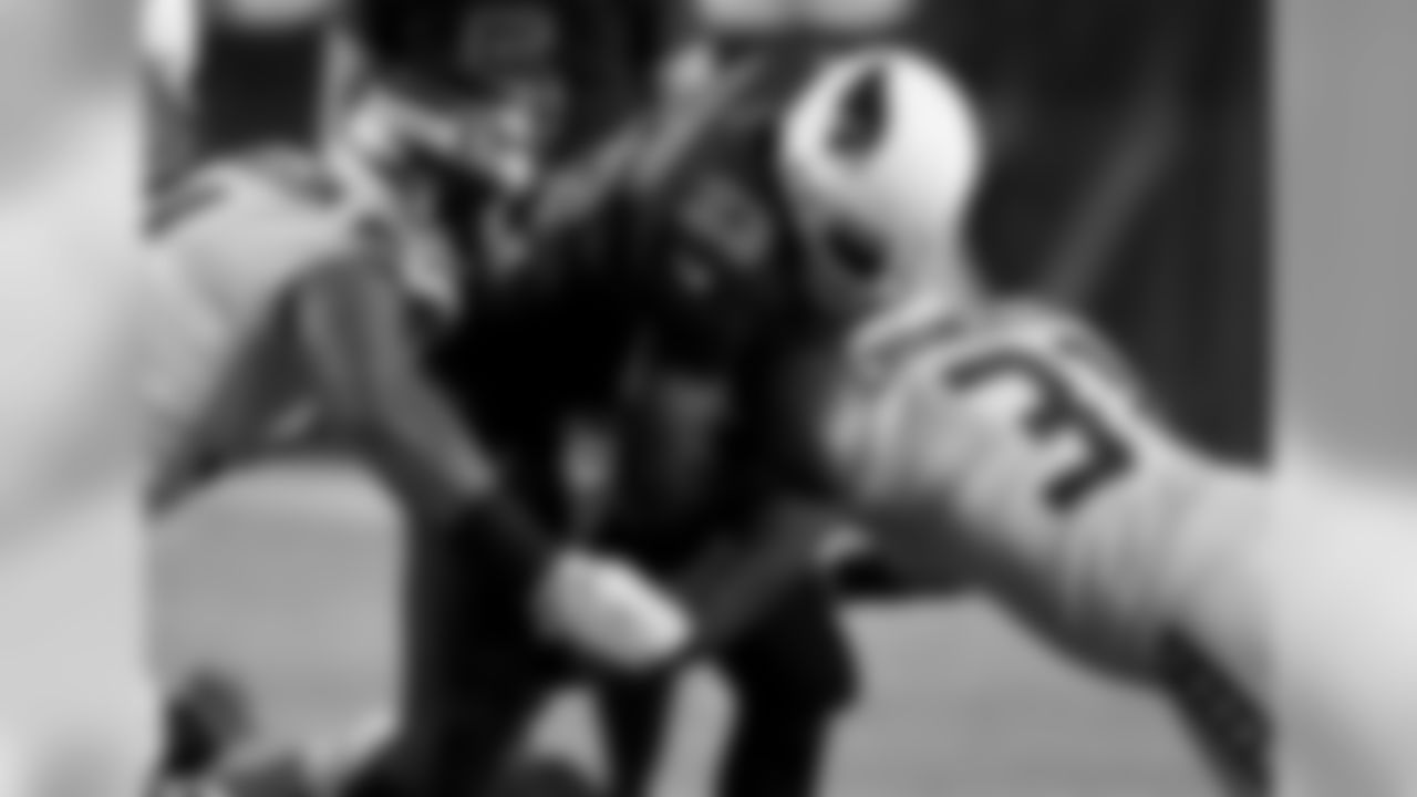 Seahawks S Kam Chancellor knocks the ball loose from Cardinals RB Adrian Peterson