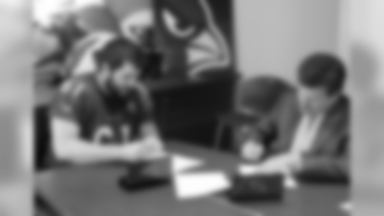 G Cole Toner signs his contract with team president Michael Bidwill