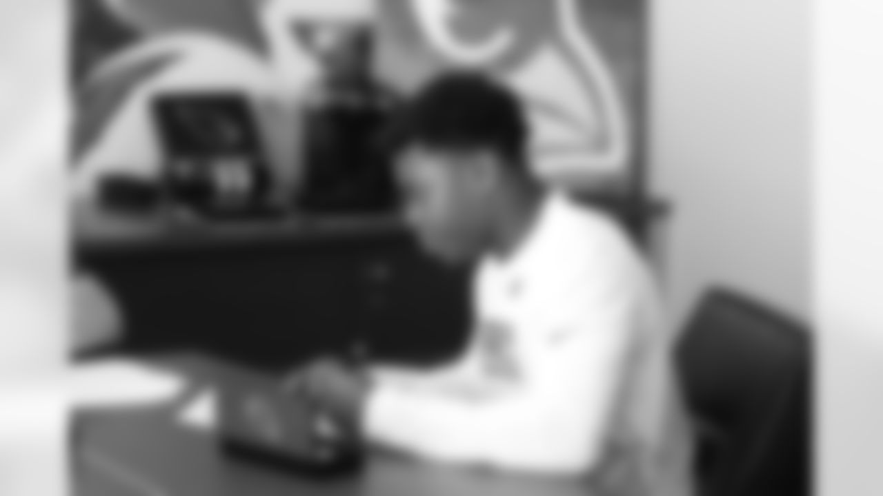 Sixth-round pick CB Rudy Ford looks over his contract