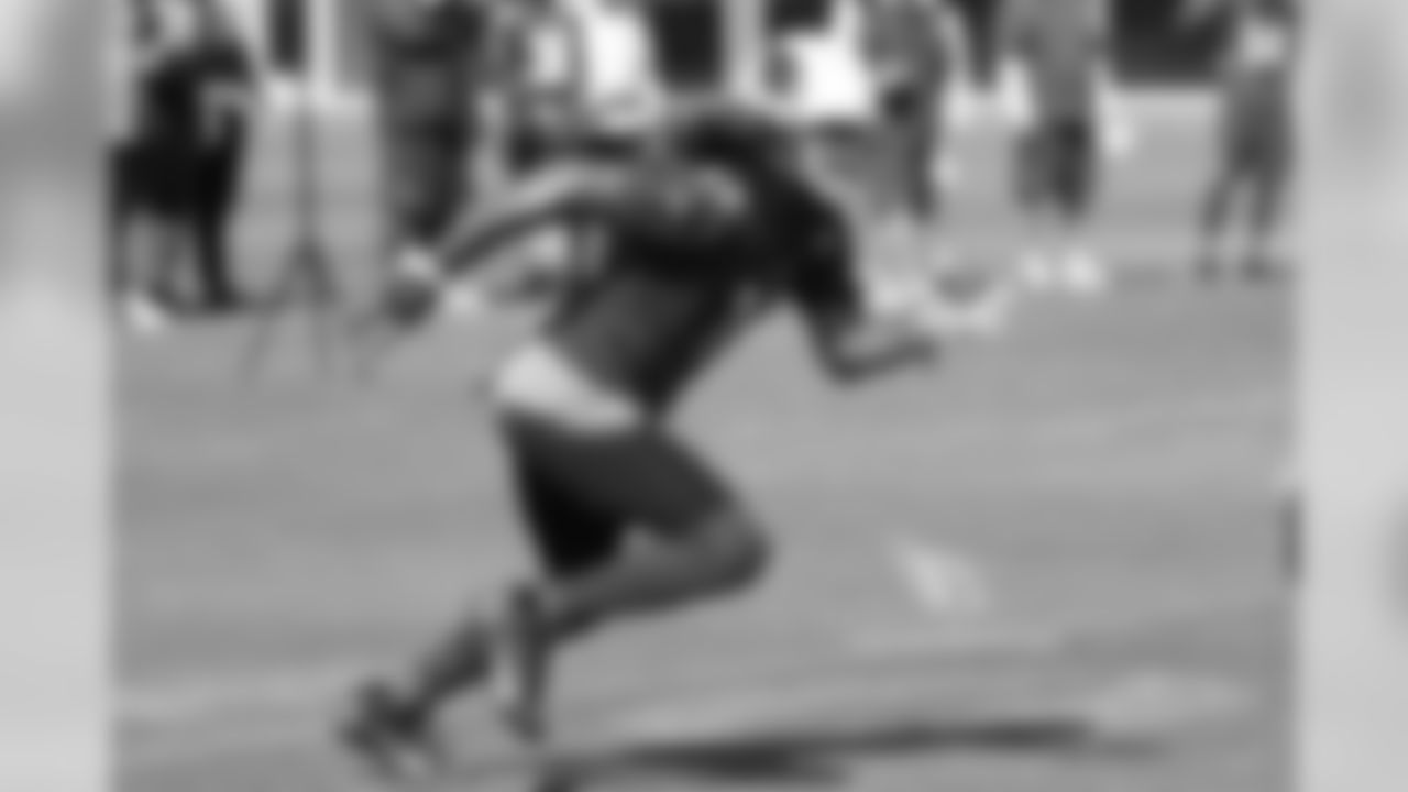 WR Larry Fitzgerald pats S Tyvon Branch after beating him for a catch