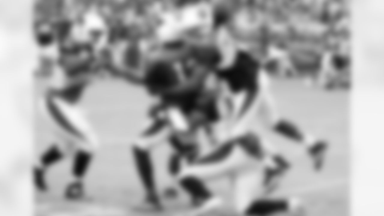 S Matthias Farley helps tackle WR Jaron Brown