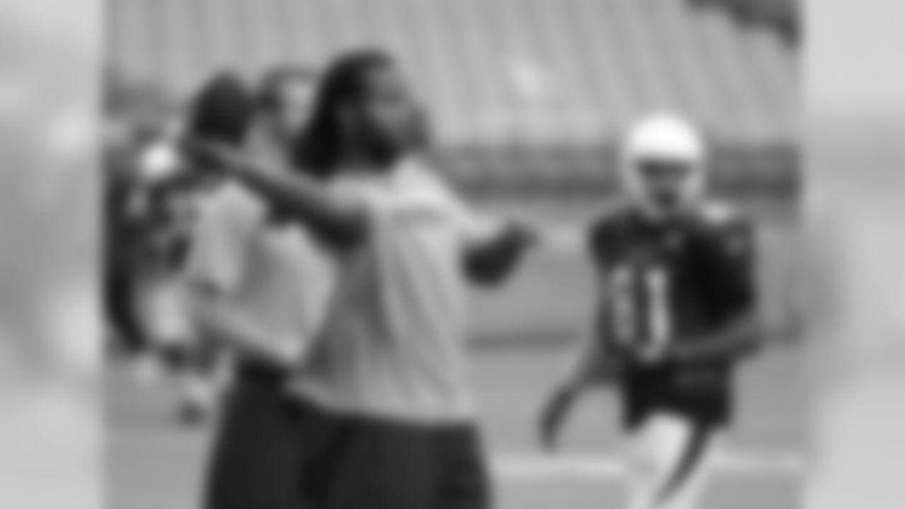 WR Larry Fitzgerald throws passes during his vets day off