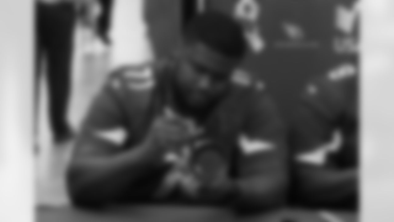 G Kaleb Johnson signs an autograph
