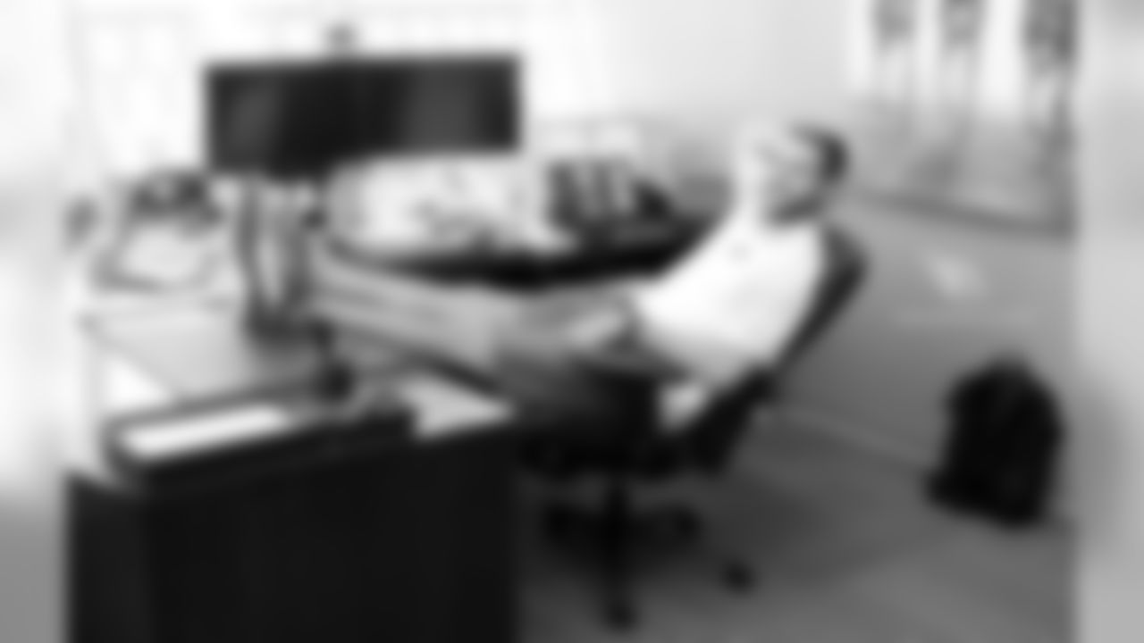 QB Trevor Knight relaxing at the desk of Sheriff Paul Penzone after the jail tour