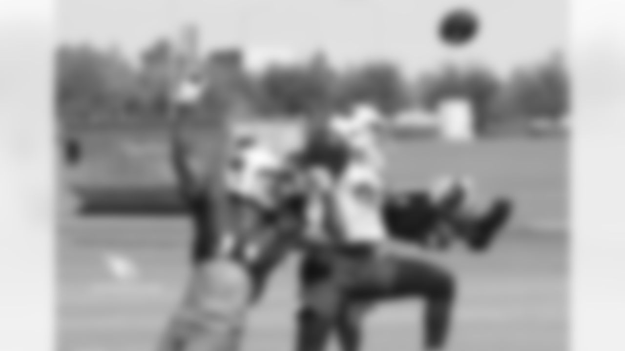 S Tyvon Branch (right) deflects a ball from WR Larry Fitzgerald