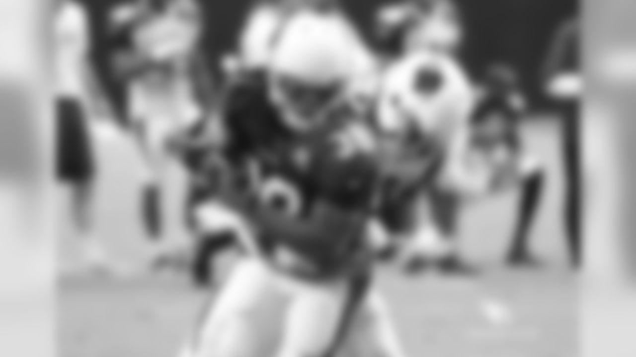 RB Andre Ellington is wrapped up by S Harlan Miller