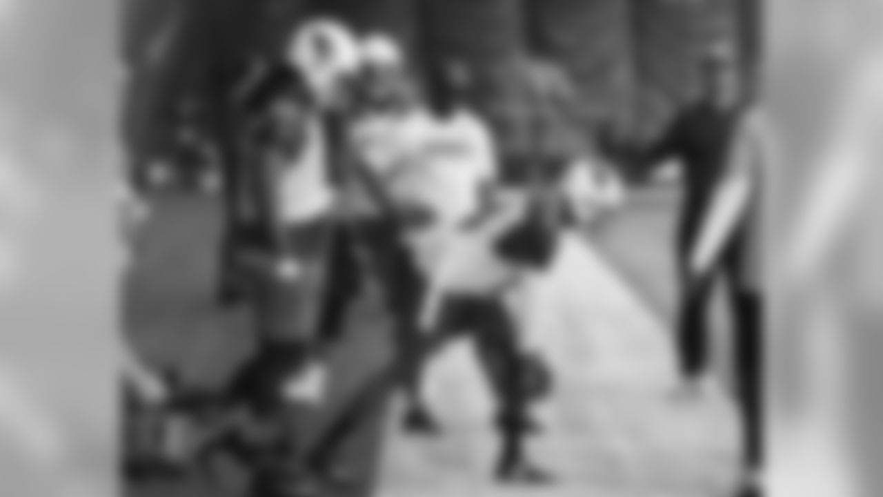 Torry Holt helps coach the wide receivers at minicamp