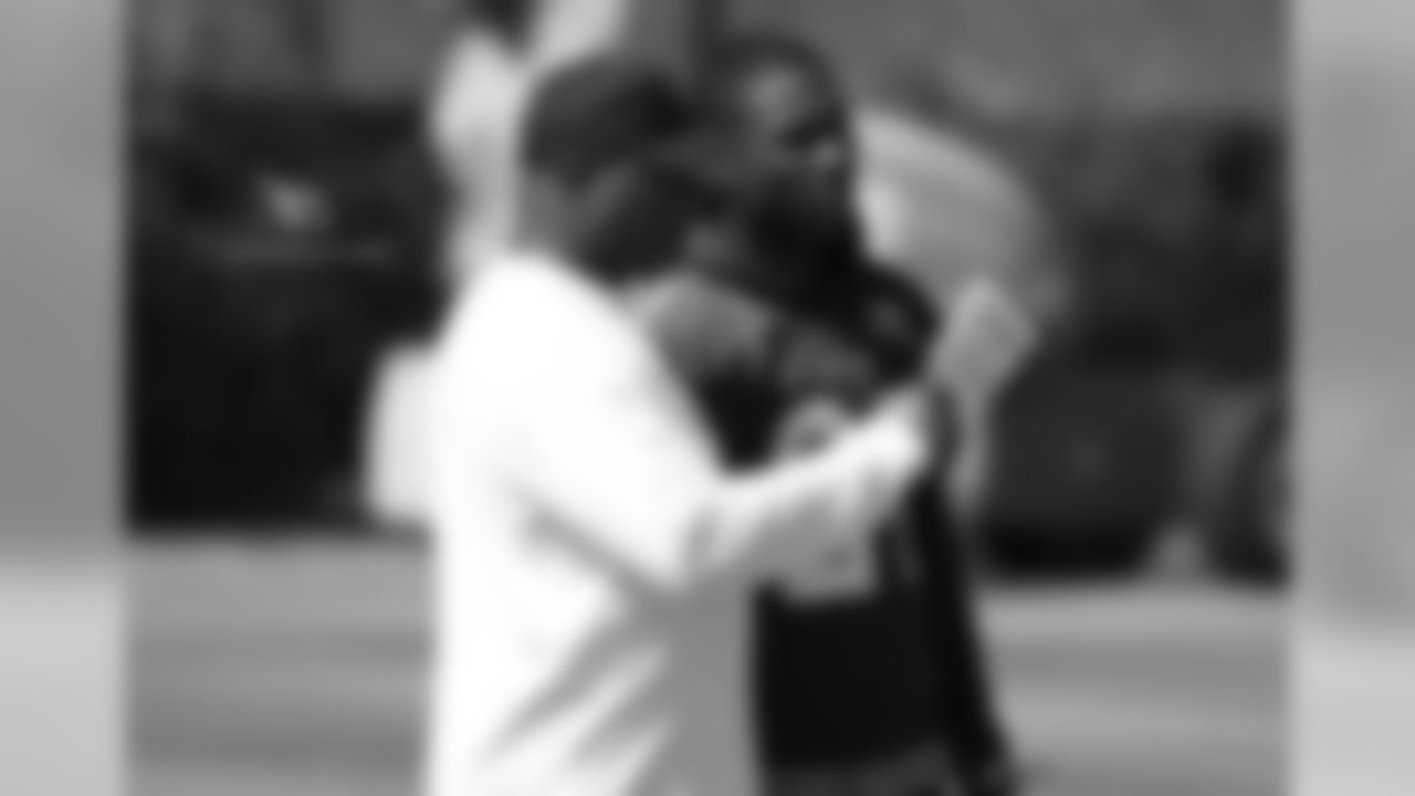 Cornerbacks coach Kevin Ross (left) talks with CB Patrick Peterson