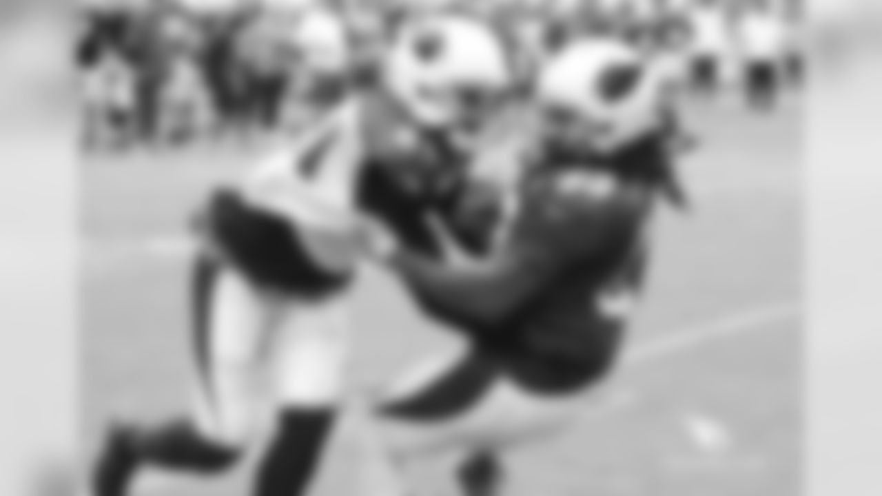 CB Patrick Peterson (left) brings down RB Chris Johnson