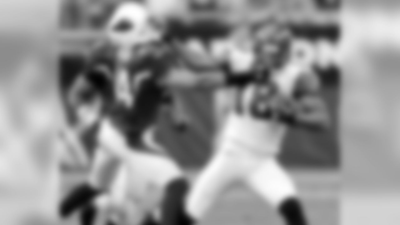 2006: The Cardinals' Robert Griffith and Seattle's D.J. Hackett grasp each other's facemask