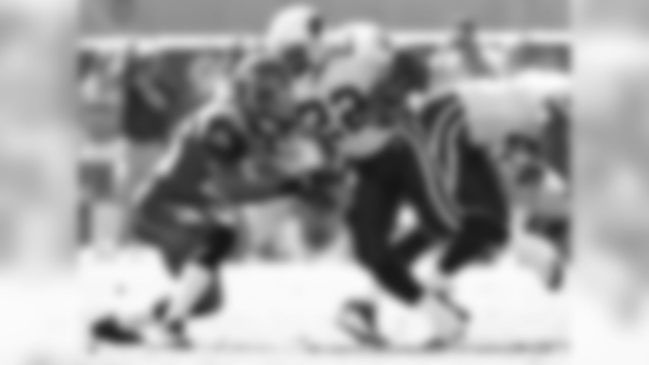 2004: RB Emmitt Smith rushes the ball and is tackled by Seattle's Ken Hamlin