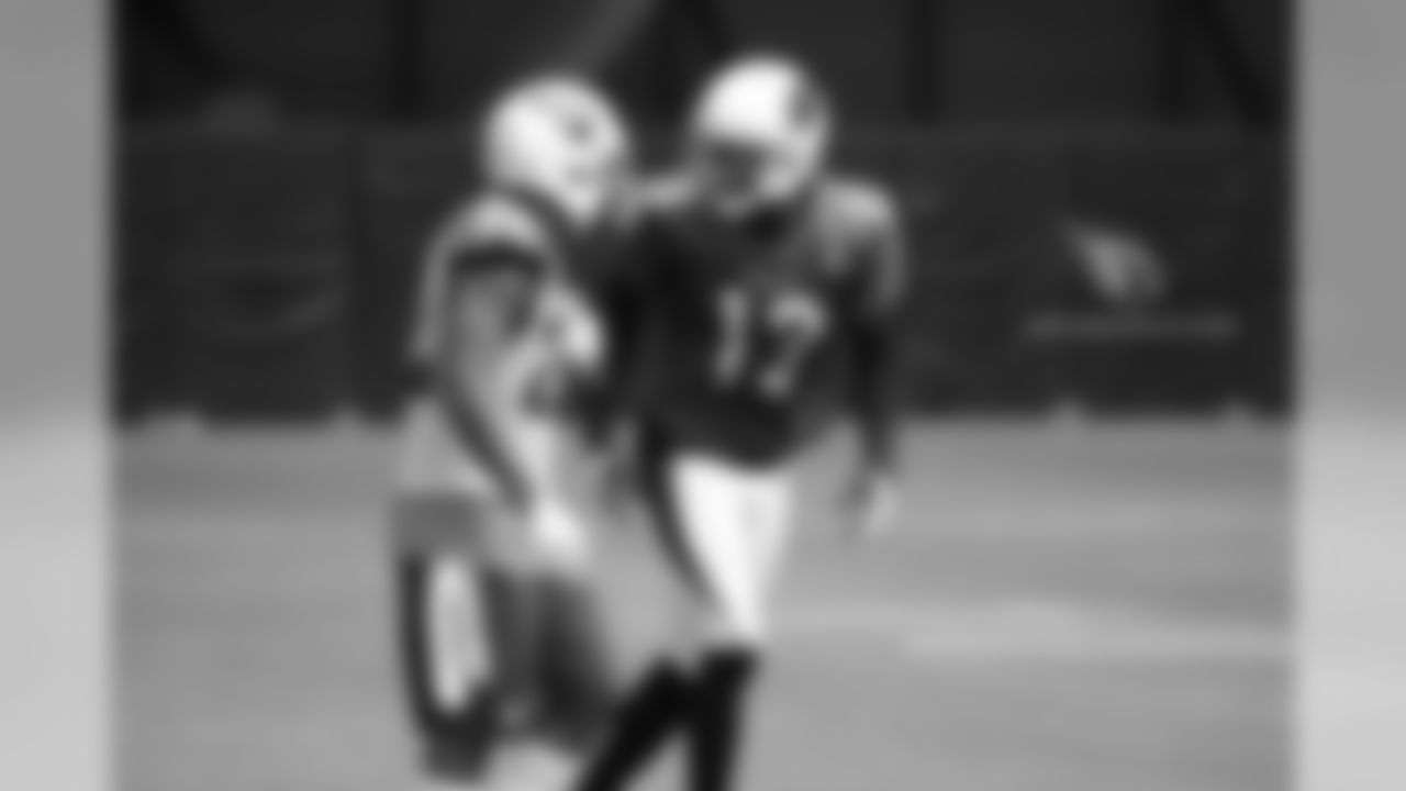 WR Jaron Brown (right) taunts S Tony Jefferson after drawing a pass interference penalty