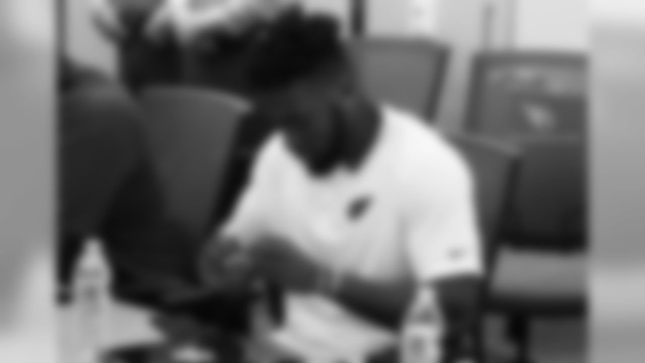 RB T.J. Logan checks out a patch given to him by the sheriff's office