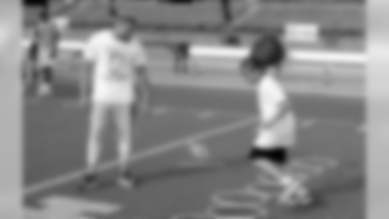 Mathieu talks a camper through a drill
