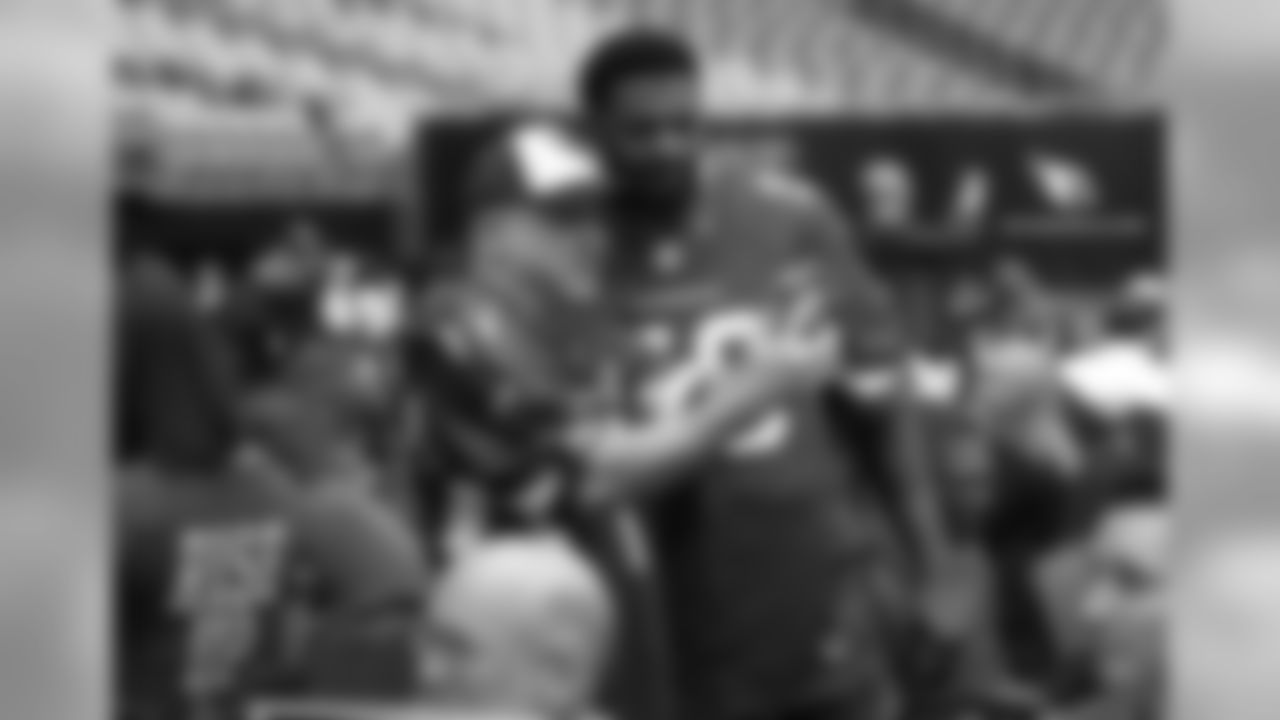 LB Karlos Dansby snaps a photo with a fan