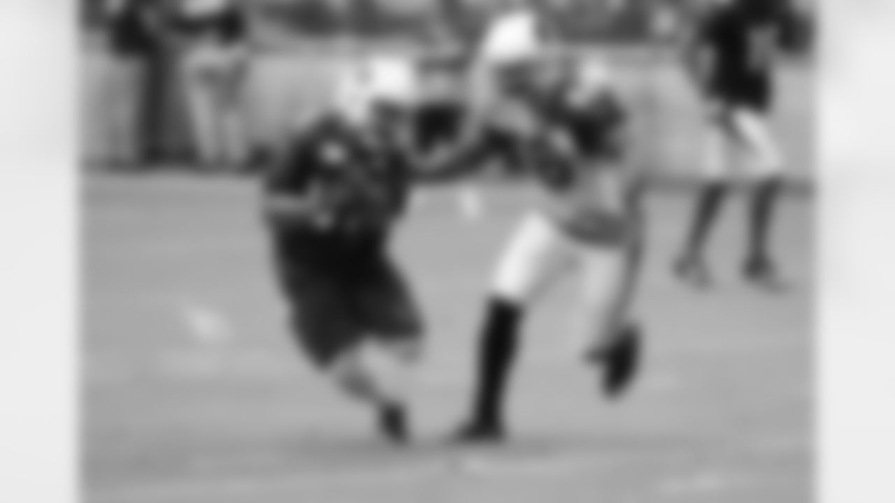 WR Amir Carlisle dodges LB Donald Butler