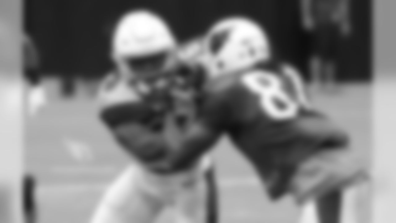 S Budda Baker tries to shed the block of WR Chris Hubert