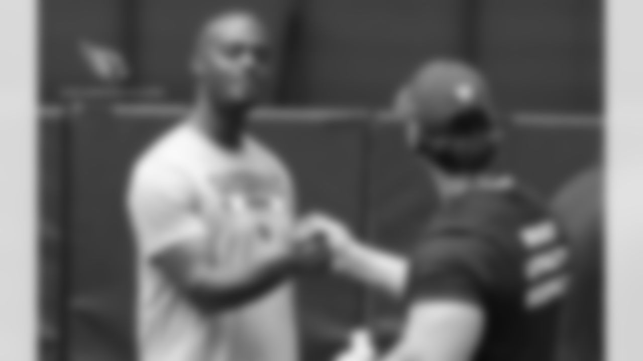 Coaching intern Plaxico Burress greets director of college scoutingDru Grigson