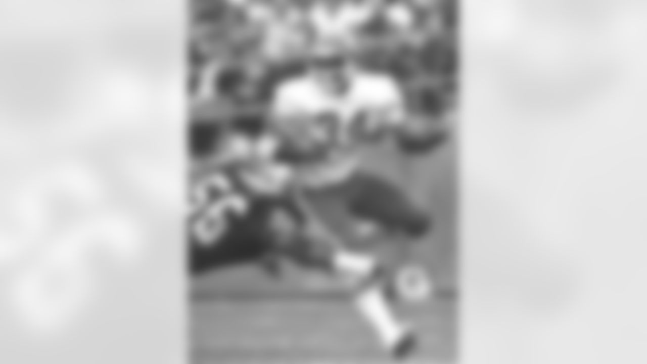 Kansas City Chiefs kick returner Eddie Payton (34) tries to break a tackle during a 1978 NFL Football game against the Oakland Raiders.
