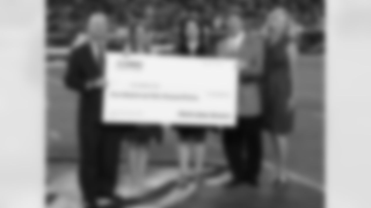 Chairman and CEO Clark Hunt and wife Tavia Hunt present The Children's Place with a check for $730,000 from the annual Chiefs Charity Game.