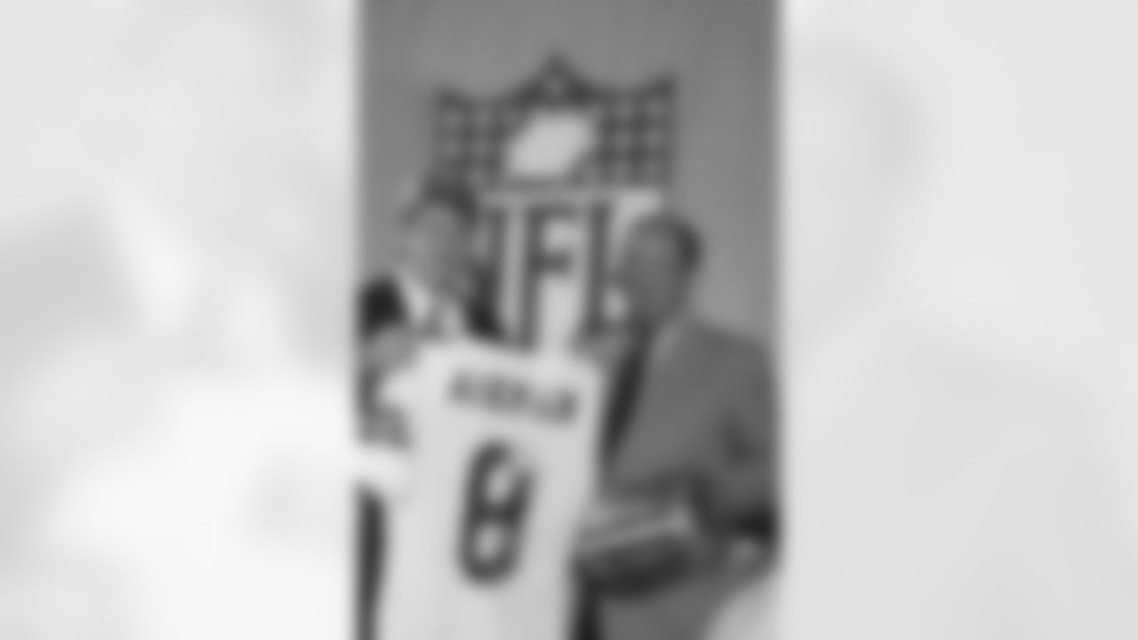 Pete Rozelle, NFL Commissioner, right, began the 54th annual draft of collegiate talent, his final draft, by announcing the selection of UCLA quarterback Troy Aikman, right, as the first pick by the Dallas Cowboys, Sunday, April 23, 1989 in New York. Aikman already has signed a six-year, $11.2 million contract with the Cowboys. (AP Photo/Mark Lennihan)