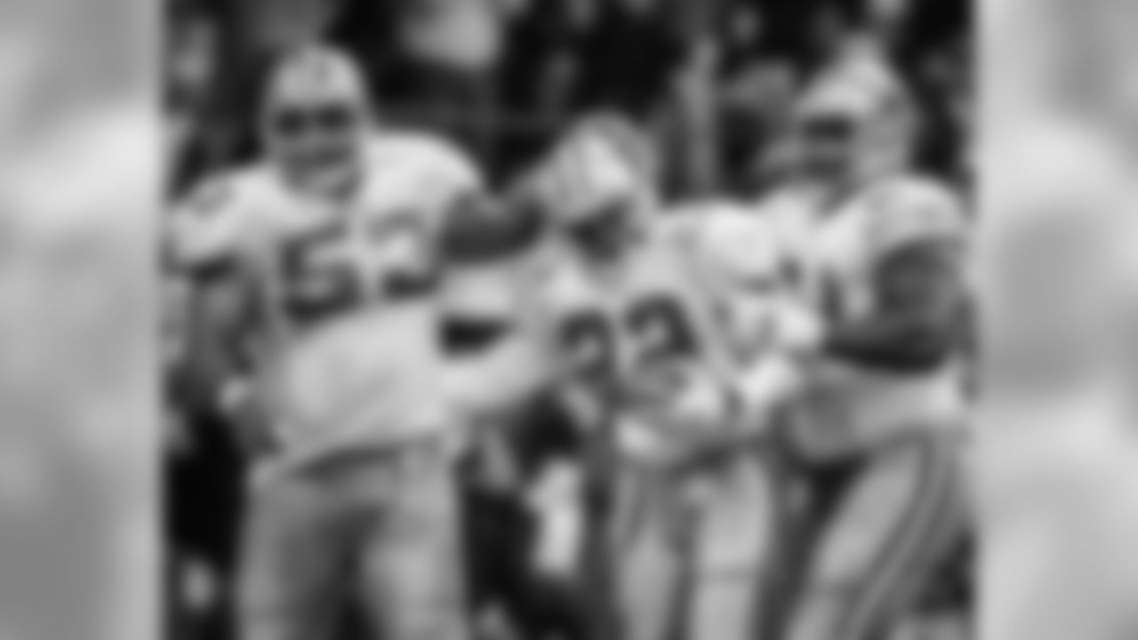 Dallas Cowboys running back Emmitt Smith (22) is congratulated by teammates Nate Newton (61) and Ray Donaldson (53) after he ran for a touchdown during the fourth quarter against the Washington Redskins in Irving, Texas, Thursday, Nov. 28, 1996. Smith ran for 155 yards. Dallas won 21-10. (AP Photo/Linda Kaye)