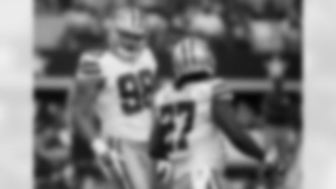 Dallas Cowboys defensive end Tyrone Crawford (98) and strong safety J.J. Wilcox (27) celebrate a defensive stop against the New York Giants during the first half of an NFL football game, Sunday, Oct., 19, 2014, in Arlington, Texas. (AP Photo/Brandon Wade)