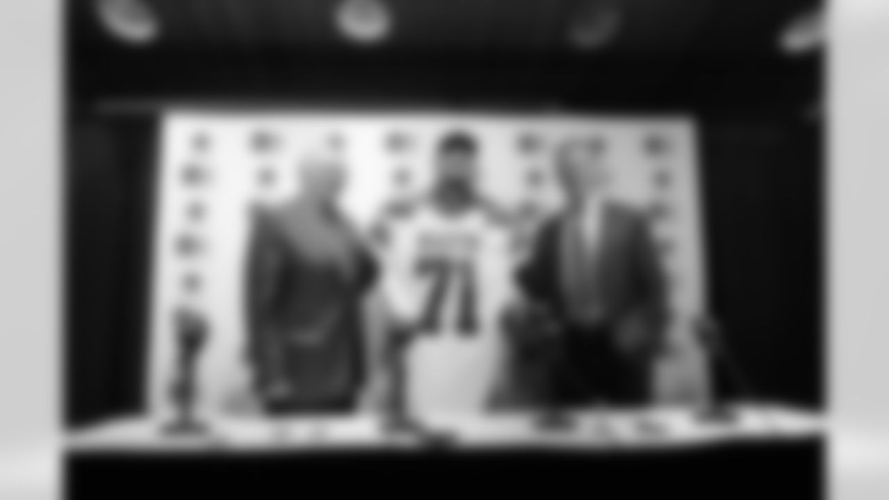 Dallas Cowboys draft pick Zach Martin, center, poses for photos with team owner Jerry Jones, left, and head coach Jason Garrett at Valley Ranch in Irving, Texas, Saturday, May 10, 2014. Martin, a Notre Dame offensive tackle, will forever be known as the player the Cowboys drafted instead of Johnny Manziel. The Cowboys took Martin with the 16th pick in the first round of the NFL draft. (AP Photo/LM Otero)