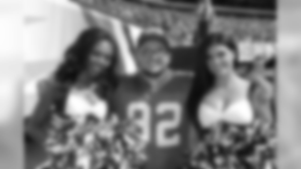 Kodi and Stephanie posing with a big Reggie White fan