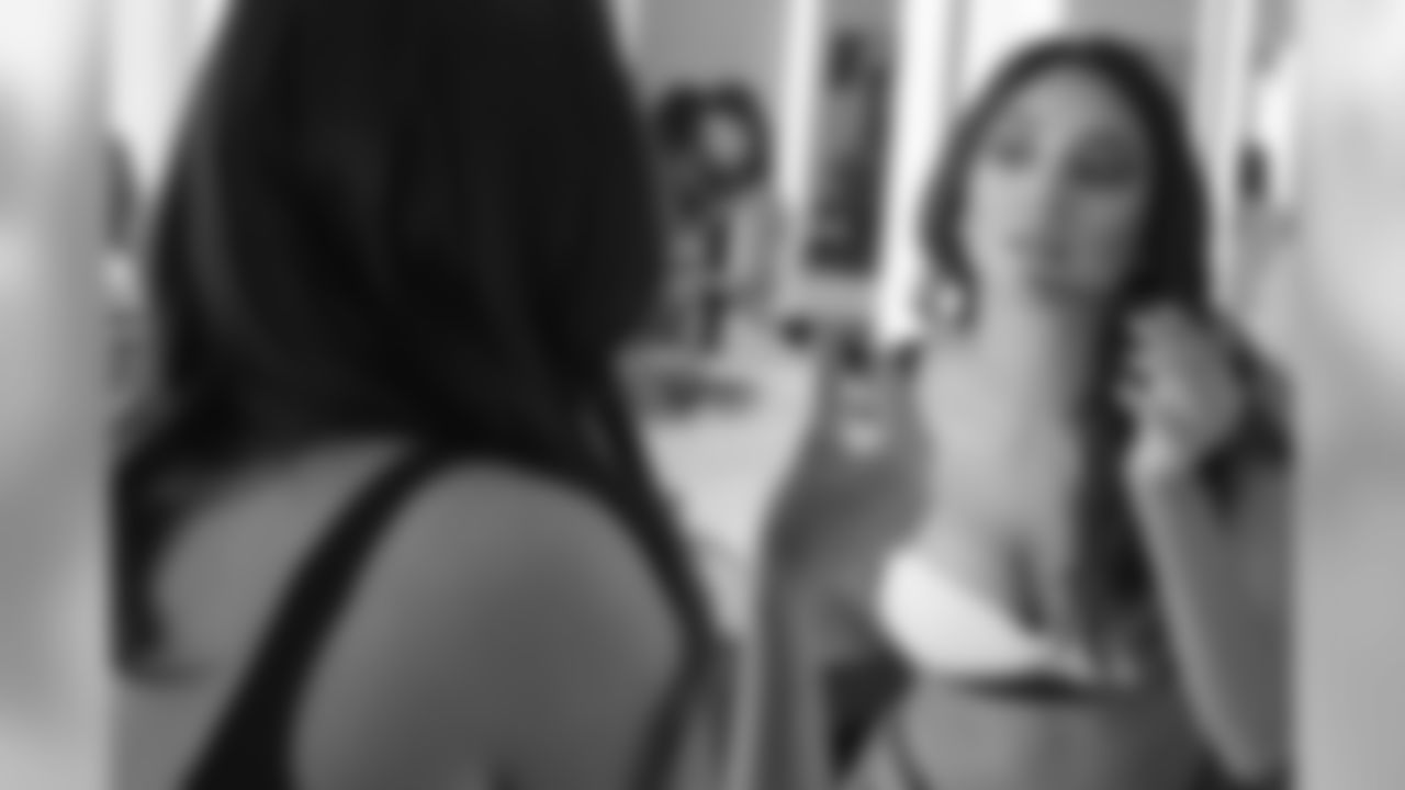 Solange touching up her makeup in the cheer locker room.