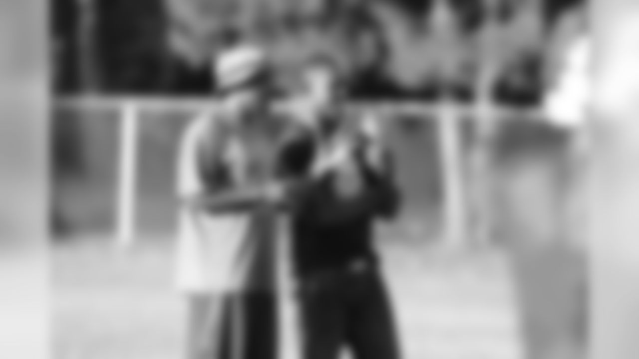 Lito Sheppard speaks with Raines coach Charles Owens
