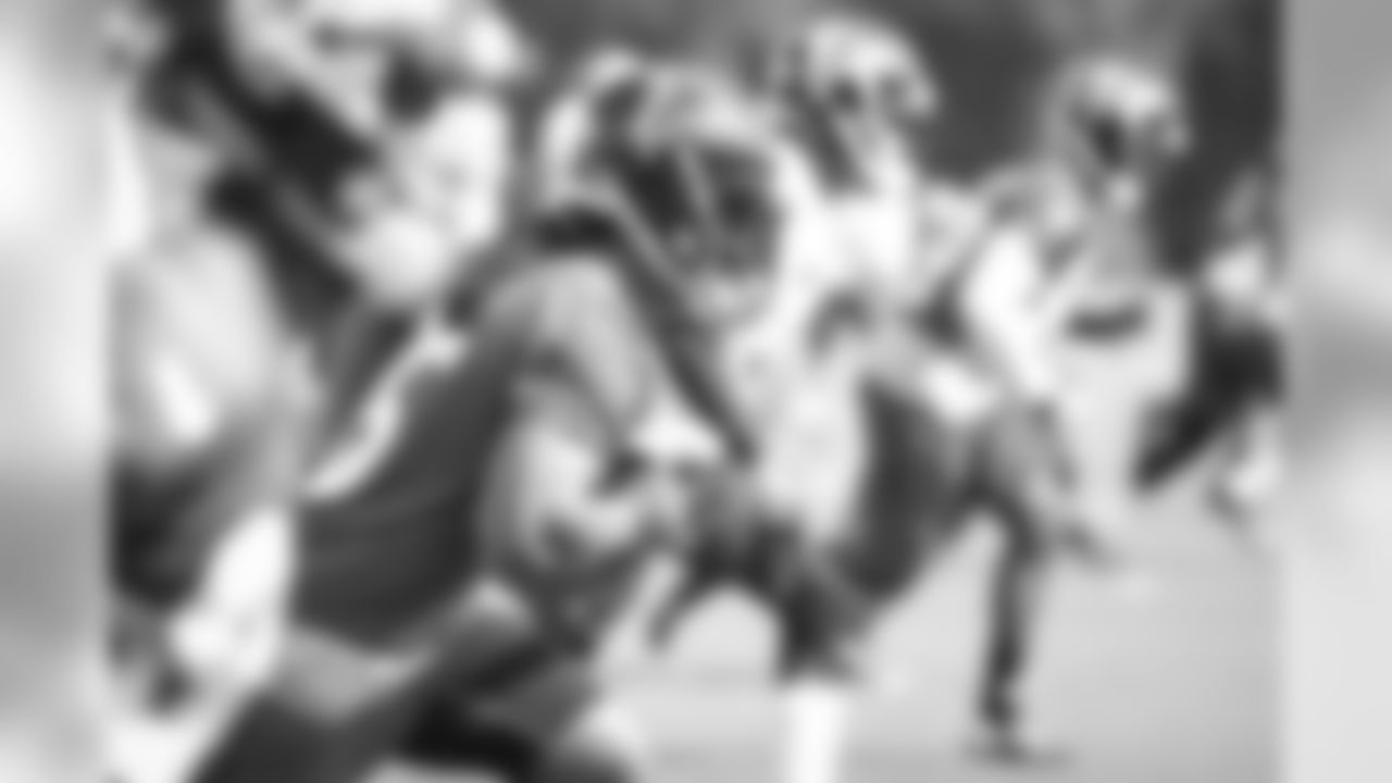 Running back Gus Johnson and his teammates participate in warmups before the hard work starts