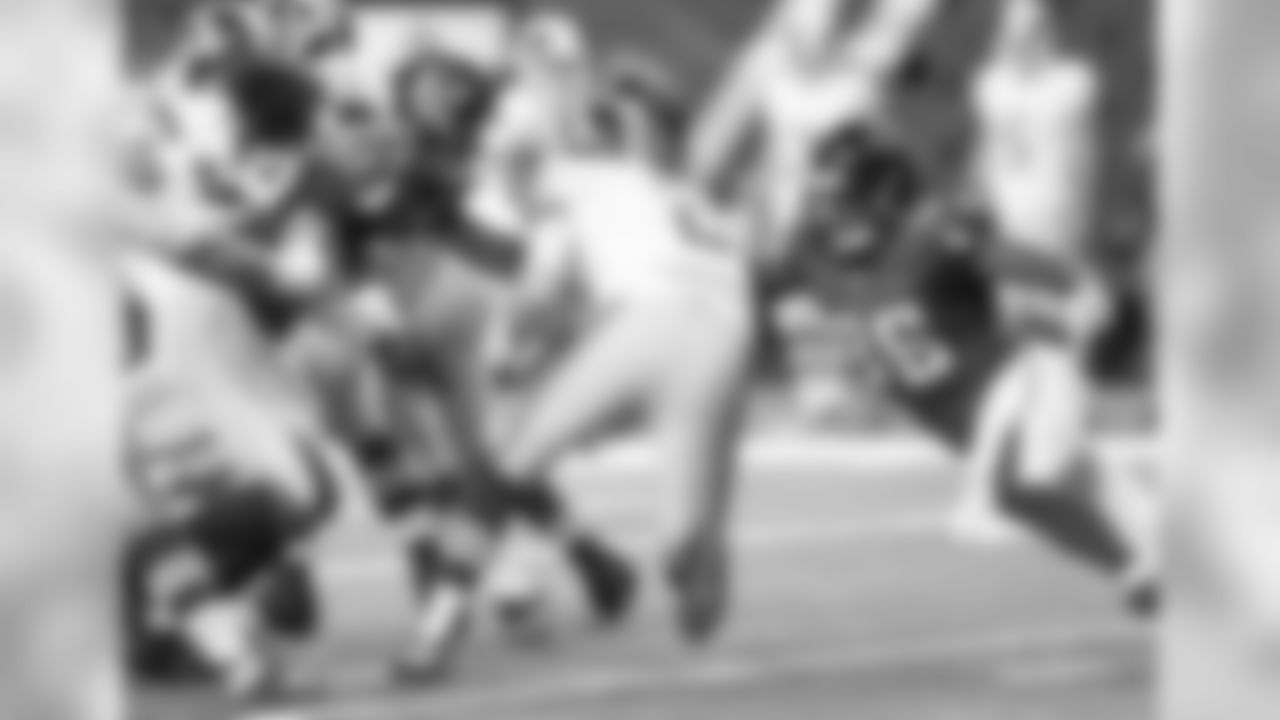 Defensive linemen Brandon Williams (75) and Nordly Capi converge on Nate Sudfeld to record a sack