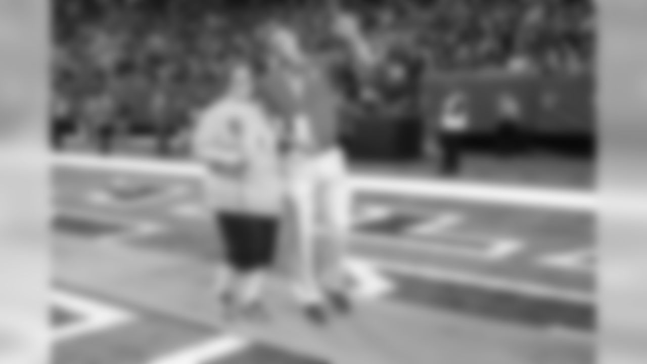 Breast cancer survivors received pink roses and were escorted out of the tunnel onto the field by Falcons alumni