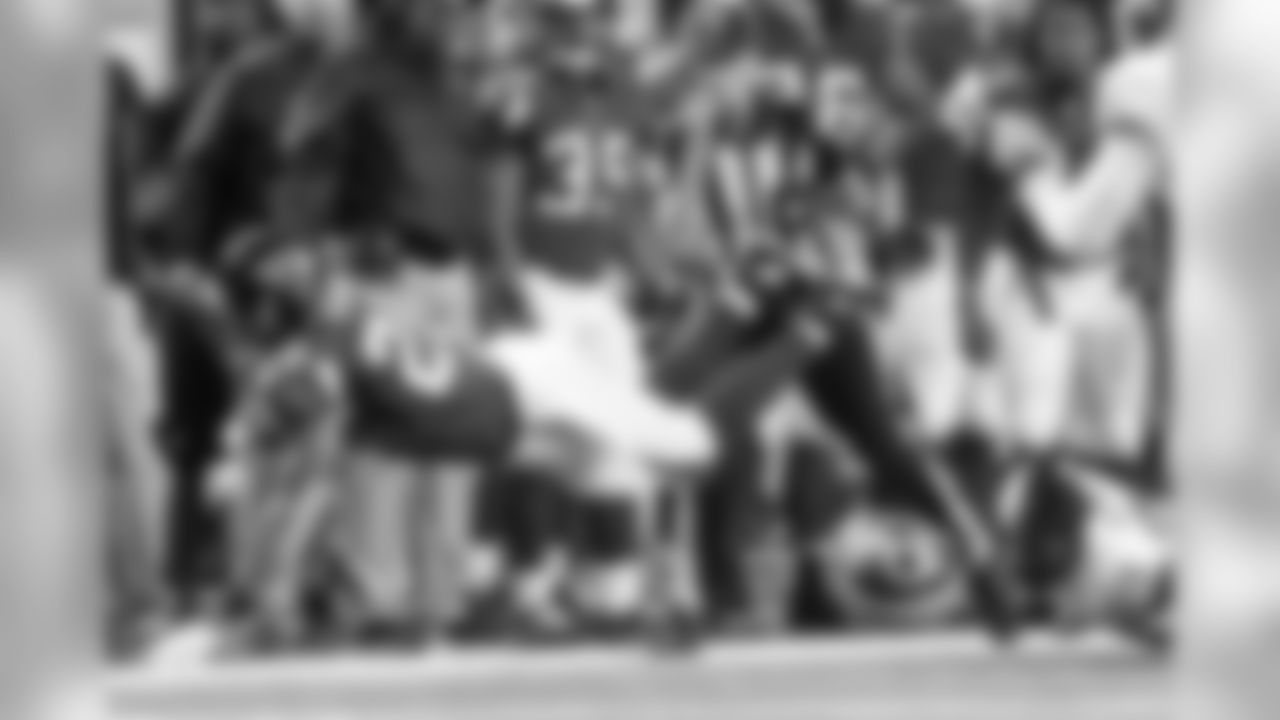 RB Brandon Wilds stretches out for extra yardage as he gets tripped up