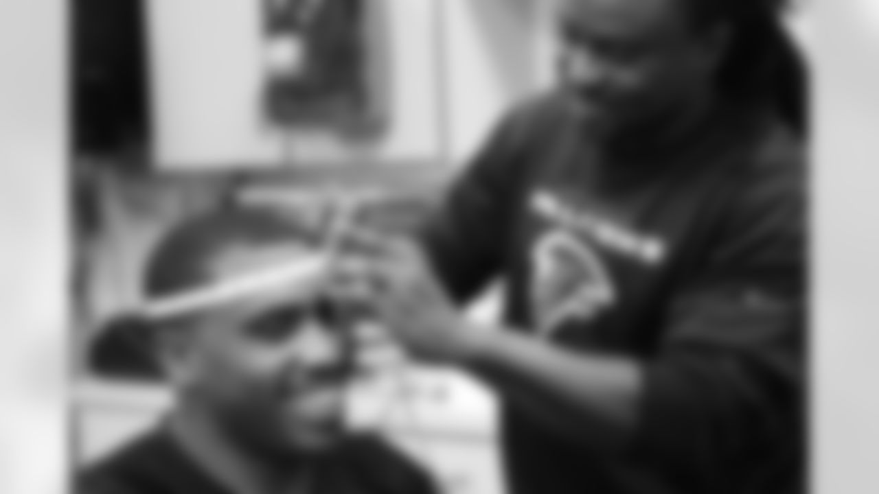 Equipment manager Kenny Osuwah measures the head of University of Georgia free agent Josh Dawson