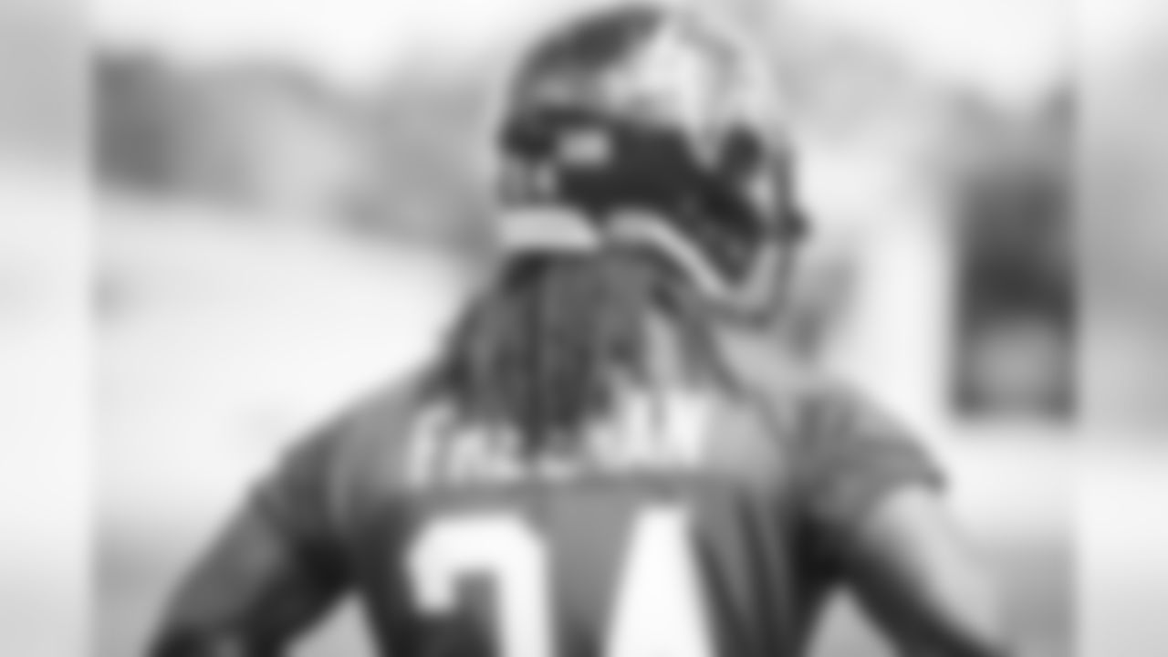 Running back Devonta Freeman looks on as special teams units practice on the fields