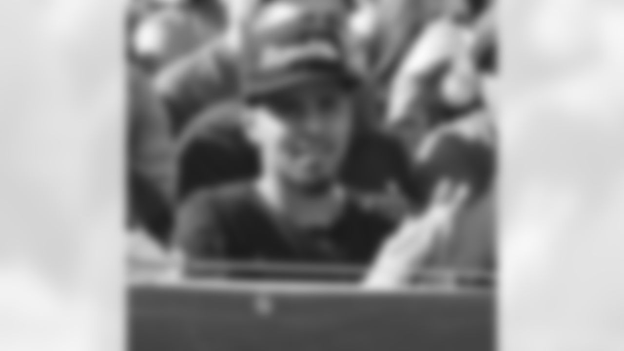 Hip hop recording artist J. Cole watches from the front row at the Jets vs 49ers game