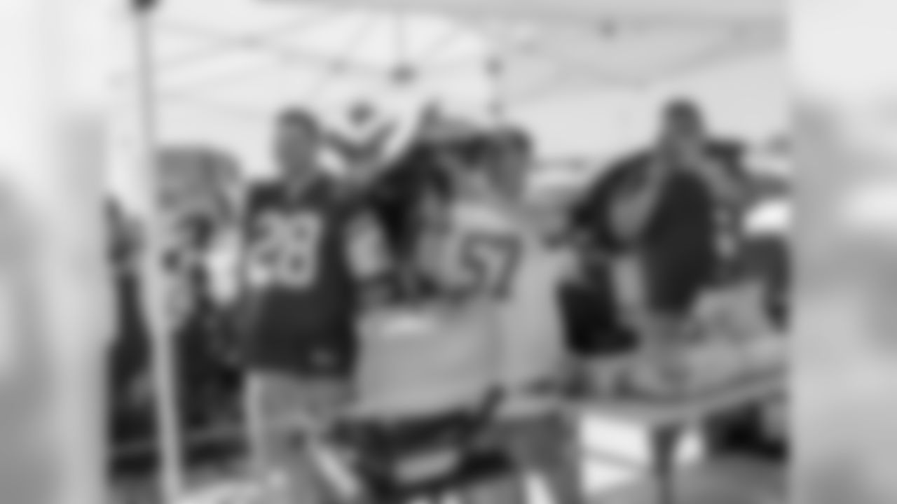 Fans crowded the parking lots early at MetLife Stadium to share their Jets pride while cooking up some hamburgers and hotdogs before entering to watch the game.