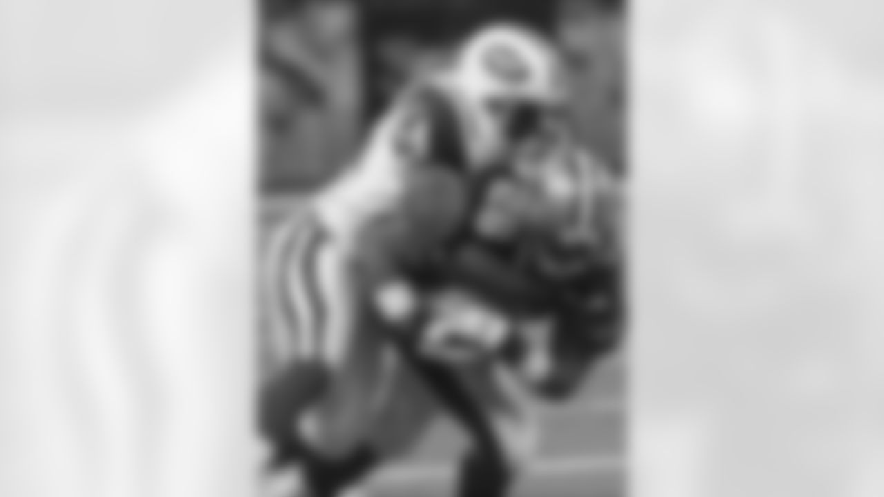 LB Victor Hobson wraps up RB Deuce McAlister during the 2004 preseason opener, a Friday the 13th loss to New Orleans, 23-13.