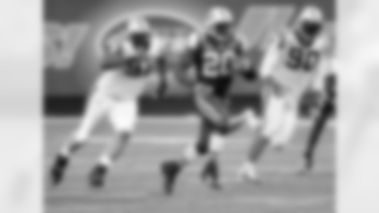 RB Thomas Jones races away from a pair of Carolina defensive linemen on one of his 25 carries in the game. He scored a touchdown and racked up 75 yards rushing en route to our 17-6 win over the Panthers.