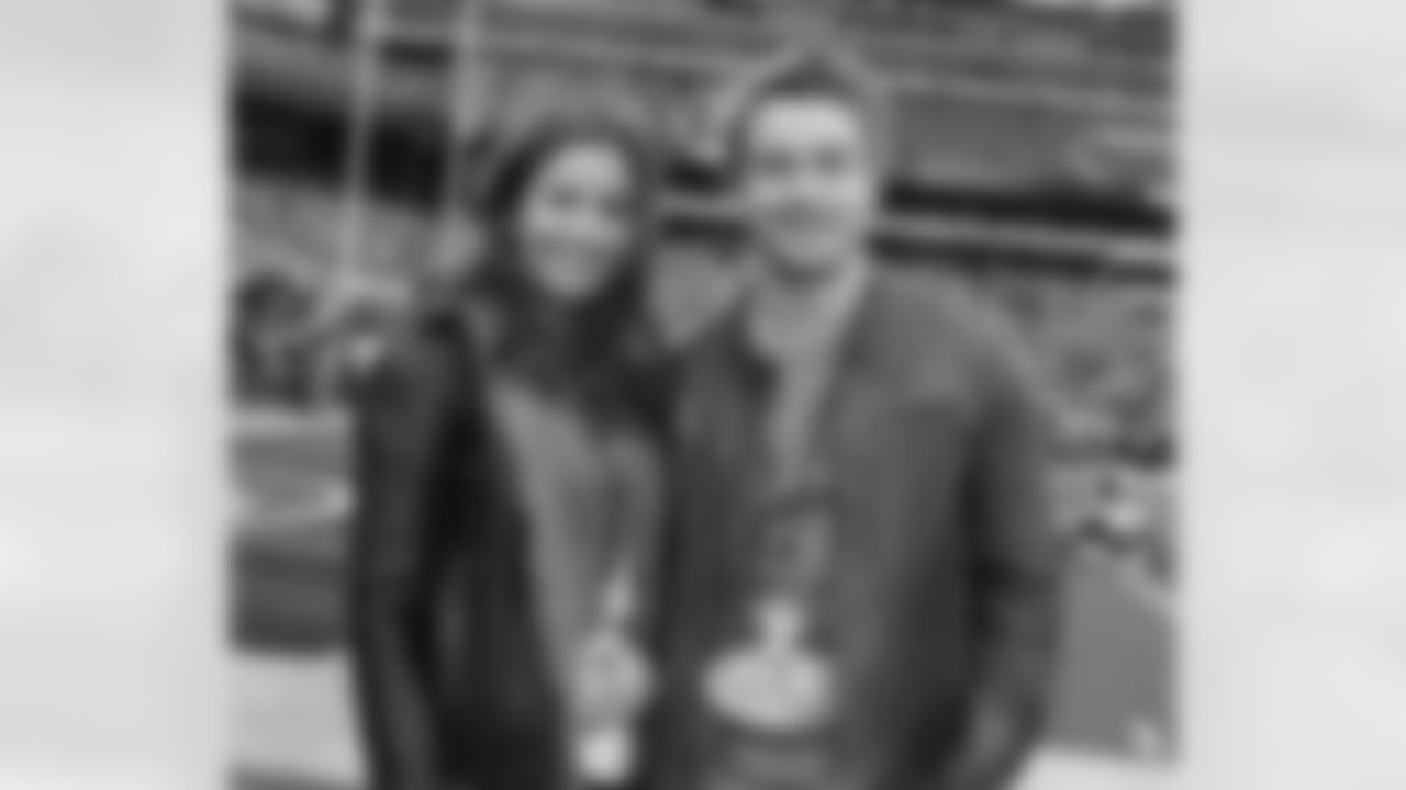 666 Park Avenue stars Mercedes Masohn and Robert Buckley pose for a photo on the sidelines before the Jets vs Dolphins game.