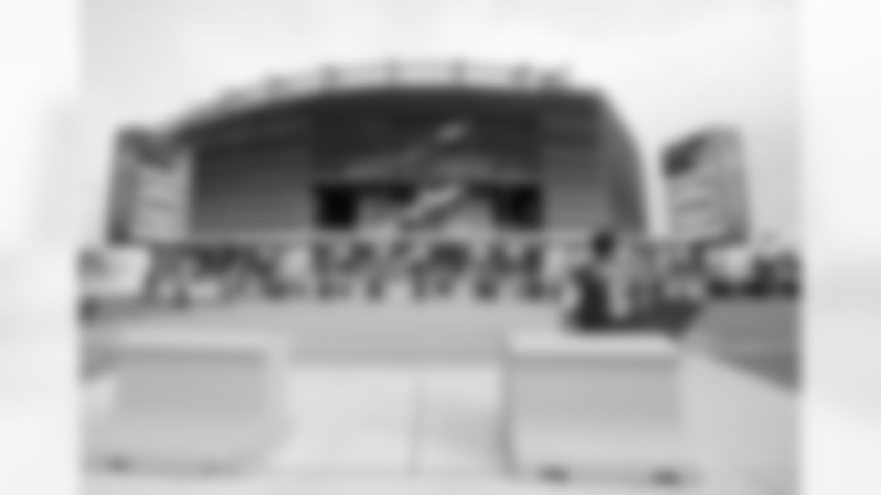 A fan waits to enter the gates at New Meadowlands Stadium before an NFL football game between the New York Jets and the New York Giants in East Rutherford, N.J., Monday, Aug. 16, 2010. (AP Photo/Peter Morgan)