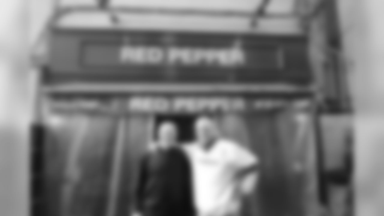 Red Batty and Pepper Burruss outside a restaurant bearing their names.
