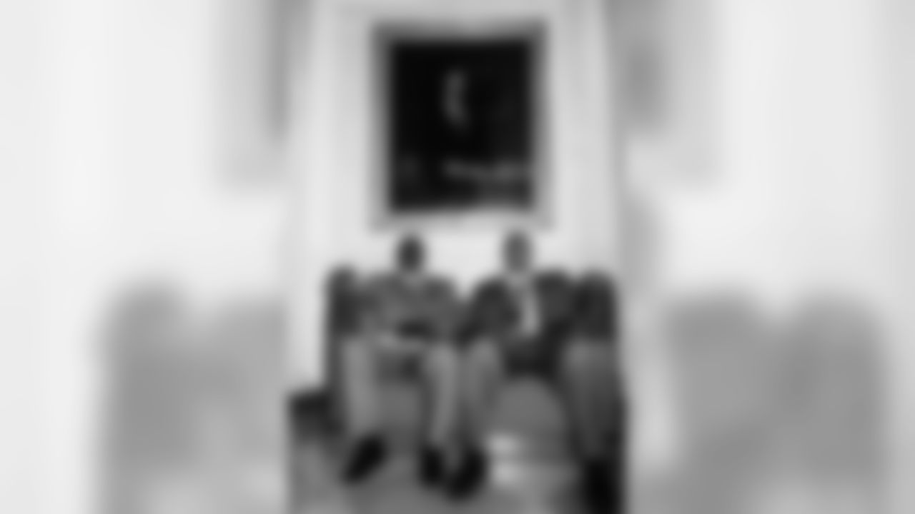 RBs Edgar Bennett & Dorsey Levens beneath a portrait of George W. Bush