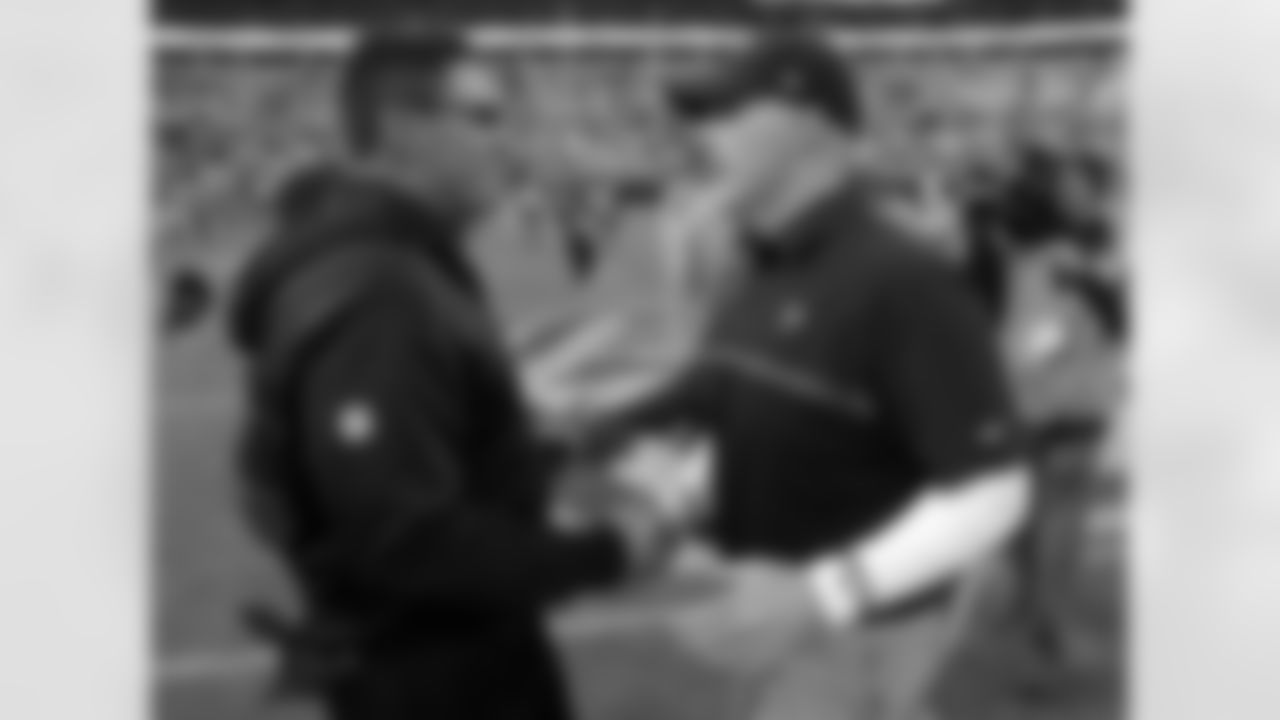 Carolina Panthers head coach Ron Rivera, left, shakes hands with Atlanta Falcons head coach Dan Quinn, right, after an NFL football game in Charlotte, N.C., Saturday, Dec. 24, 2016. The Falcons won 33-16. (AP Photo/Bob Leverone)