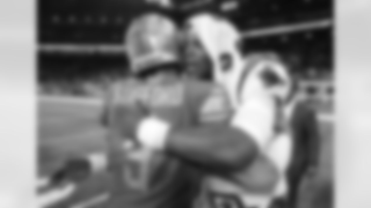 Carolina Panthers quarterback Cam Newton, right, hugs Detroit Lions quarterback Matthew Stafford (9) after an NFL football game, Sunday, Oct. 8, 2017, in Detroit. Carolina won 27-24. (AP Photo/Paul Sancya)