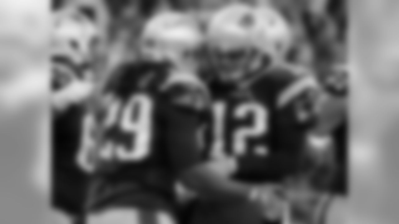 New England Patriots running back LeGarrette Blount, left, celebrates his touchdown against the New York Jets with Tom Brady (12) during the second half of an NFL football game, Saturday, Dec. 24, 2016, in Foxborough, Mass. (AP Photo/Elise Amendola)