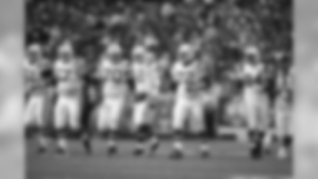 Members of the New England Patriots offensive line walk down the field against the Denver Broncos during an NFL football game in Denver, Sunday, Oct. 11, 2009. (AP Photo/Jack Dempsey)