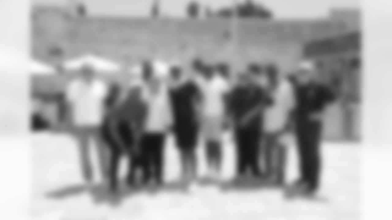 Joe Monatana, Cris Cater, Andre Tippett, Robert Kraft, Eric Dickerson, Bruce Smith, Jim Brown, Mean Joe Green and Roger Staubach at the Western Wall.